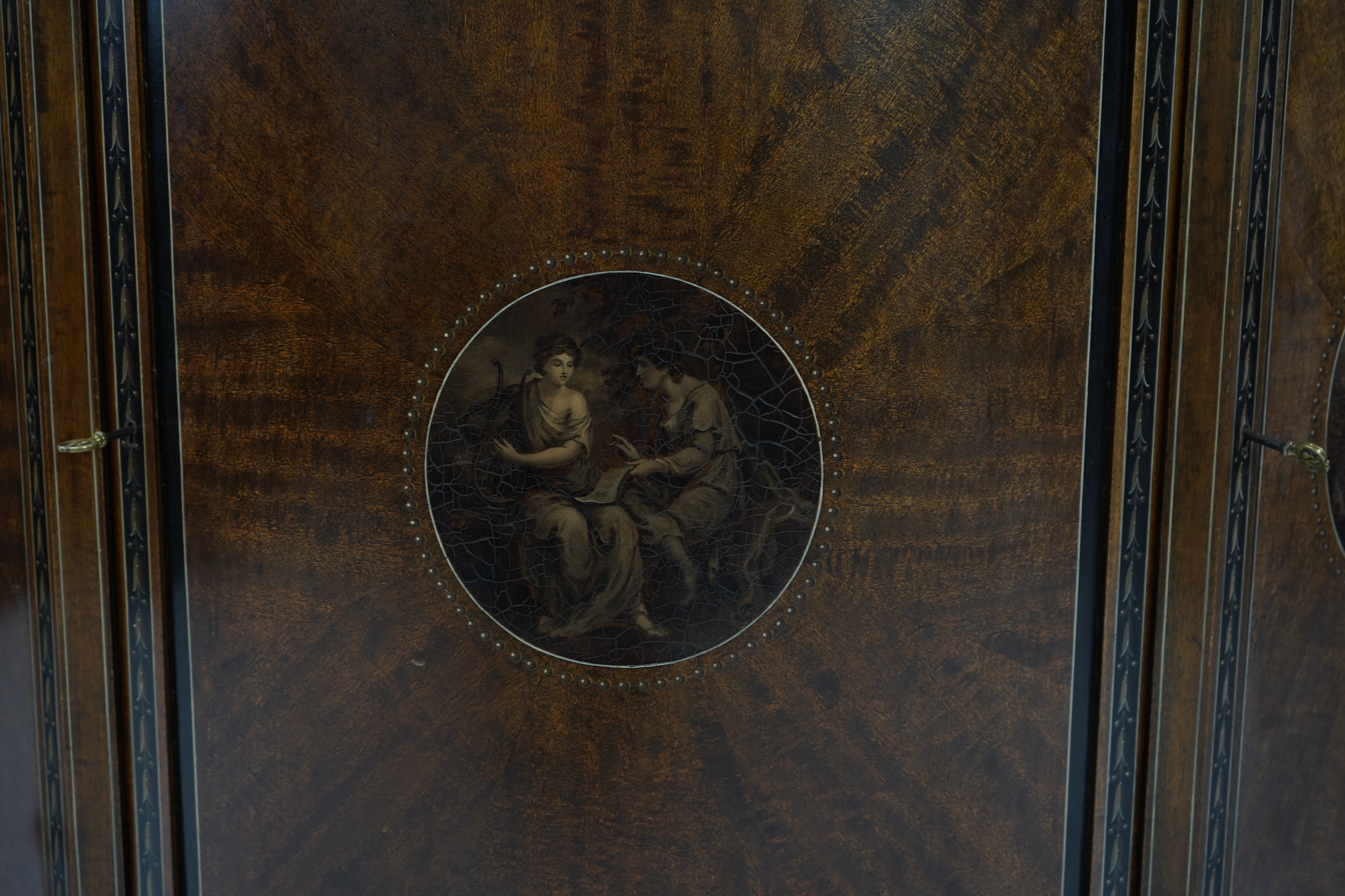 An Edwardian Sheraton Revival painted mahogany bowfront side cabinet